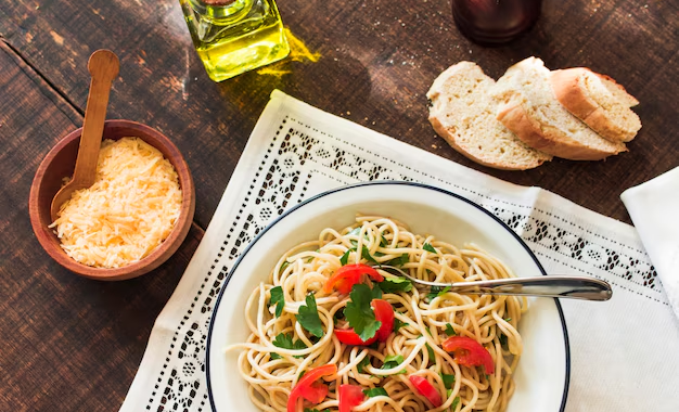 A delicious plate of Spaghetti Aglio e Olio garnished with fresh parsley and red chili flakes.