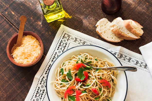 A delicious plate of Spaghetti Aglio e Olio garnished with fresh parsley and red chili flakes.