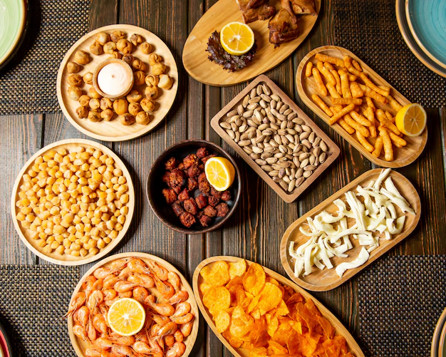 Variety of vegan snacks including roasted chickpeas, fruit bars, veggie chips, and homemade granola bars.